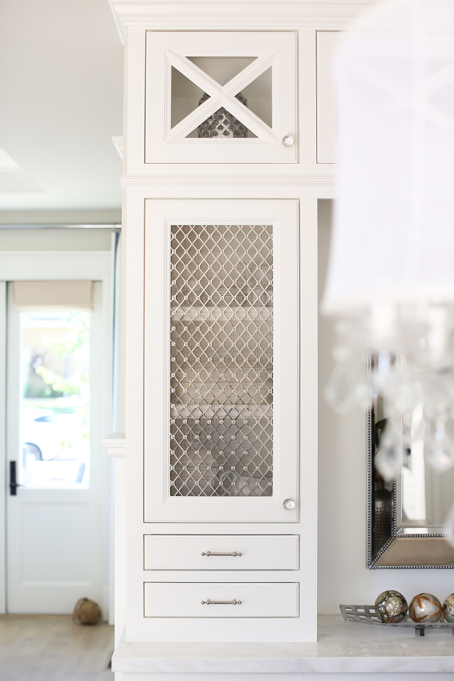 Wire Mesh Grilles. The cabinet, painted in a soft white, features x mullion, glass knobs and Wire Mesh Grilles. Wire Mesh Grilles #WireMeshGrilles #WireMeshGrillescabinet #Cabinetdoors #WireMeshGrilledoors Patterson Custom Homes. Interiors by Trish Steele, Churchill Design.
