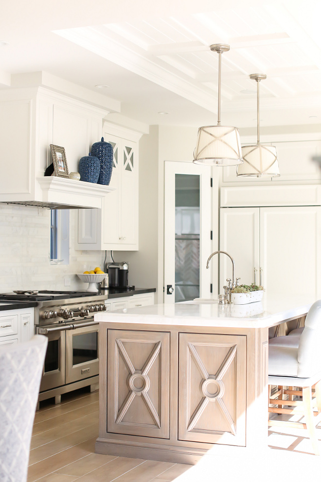 Kitchen island. Kitchen island mullion. Kitchen island design. Kitchen island lighting. White oak island. The island countertop is Calacatta Michelangelo. The perimeter countertop is Labrador Black Granite. Patterson Custom Homes. Interiors by Trish Steele, Churchill Design.