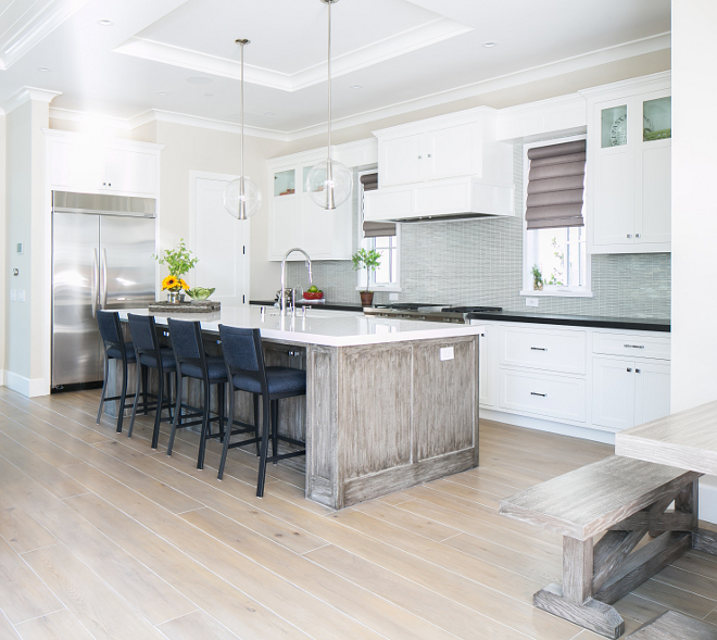 Kitchen. Open concept kitchen. This open-concept kitchen features sleek white cabinets, modern lighting and a whitewashed island with white quartz countertop. The island is custom made by the builders local finish carpenter. It is made of white oak with a custom stain applied. #kitchen #openconcept #openconceptkitchen #whitequartz Patterson Custom Homes. Brandon Architects, Inc.