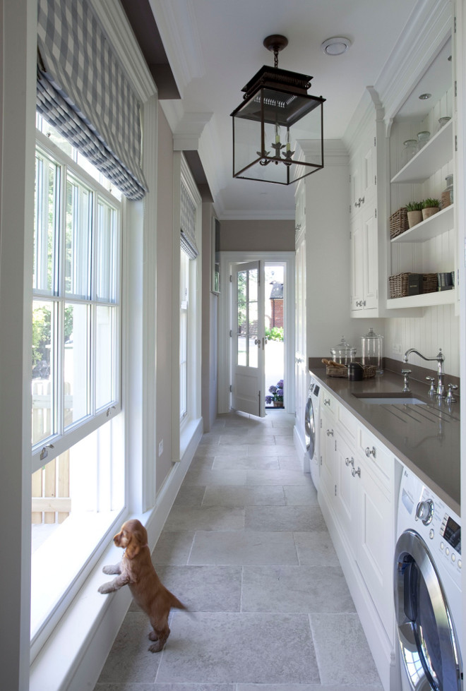 Mudroom Laundry Room Combined. Mudroom Laundry Room. Great mudroom laundry room design featuring quartz countertop and natural stone floor tiles. Lighting is Honore Lantern by Suzanne Kasler in Antique Zinc. #laundryroom #mudroom #LaundryRoomMudroom #LaundryRoomMudroomCombined #HonoreLantern #SuzanneKasler Hayburn & Co 