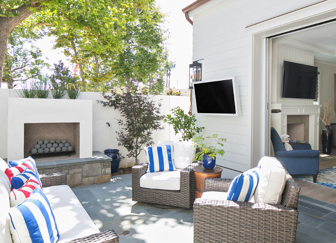 The family room opens to a private courtyard with outdoor fireplace. Patterson Custom Homes. Brandon Architects, Inc.