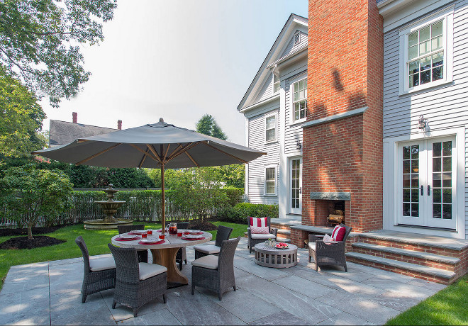 Backyard patio with outdoor brick fireplace. Siemasko + Verbridge