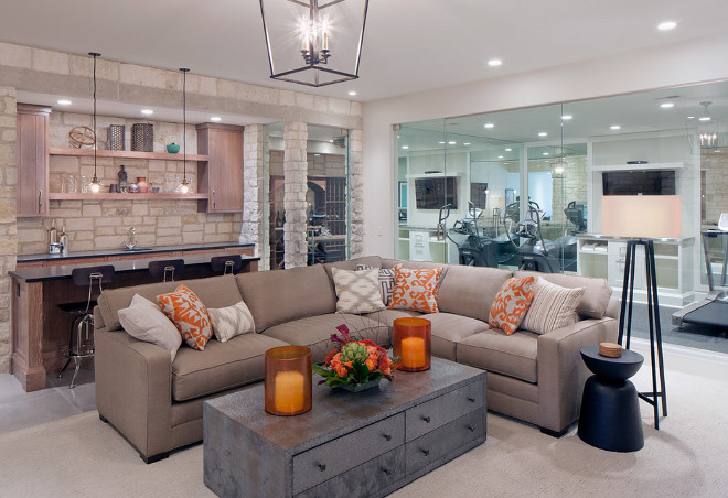 Basement living room opens to a glass enclosed gym. Basement Gym. Basement. Home Gym. #Basement #HomeGym #BasementGym Scott Christopher Homes