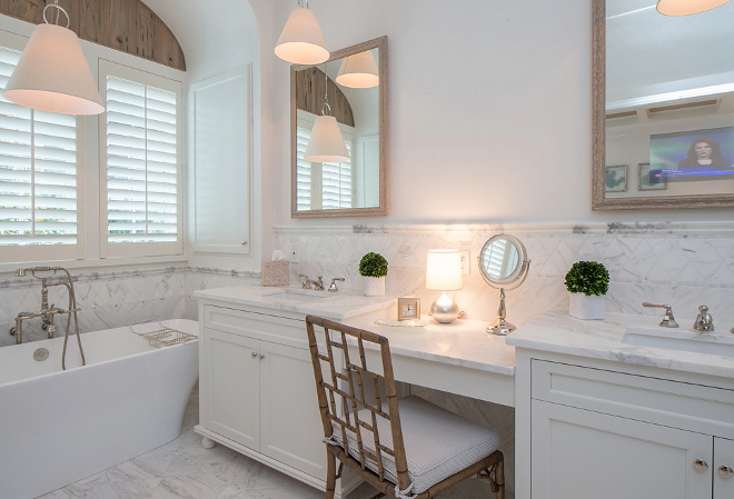 Bathroom Sources. Tile and countertops are Calcutta Gold. Faucets are Rohl. Tub is Victoria and Albert. Lighting is from Hudson Valley and vanity chair is from Global Views. The custom mirrors are by Suera Company with built in TVs. #bathroom #bathroomsources Interiors by Courtney Dickey of TS Adams Studio.