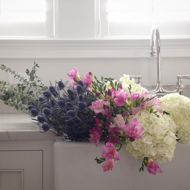 Farmhouse sink. Kitchen Farmhouse sink with flowers inside. Beautiful homes. #Farmhousesink #flowers #beautifulhomes Old Seagrove Homes.