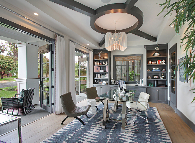 Home Office with French Doors to Porch. The home office also feature French doors to the front porch, custom white drapes with banded trim by Fabricut and curated accessories. #Homeoffice #Frenchdoors #porch Patterson Custom Homes. Interiors by Trish Steele of Churchill Design. 