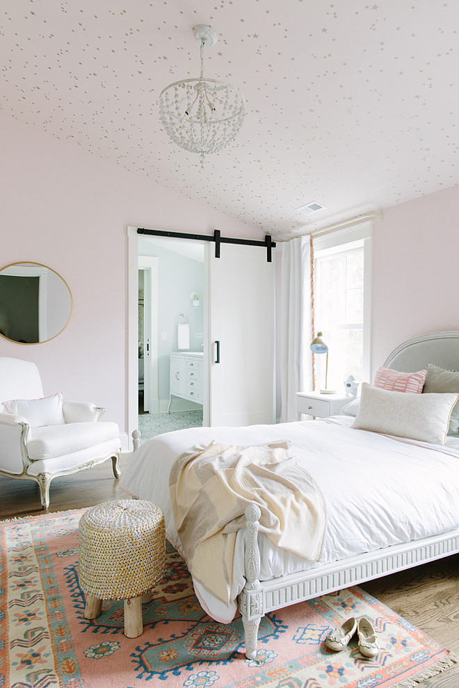 Kids bedroom with pale pink walls and stars on the ceiling. Kate Marker Interiors.