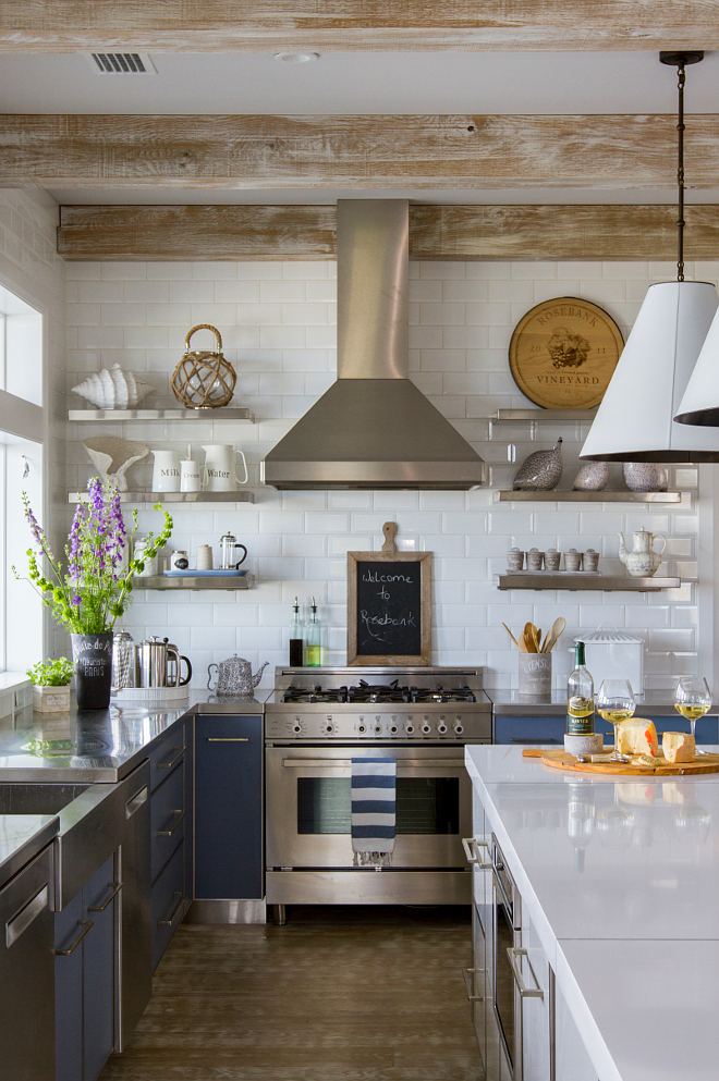 Kitchen. Rustic kitchen with Two toned Cabinets. Perimeter countertop is custom stainless steel. Island countertop is White Zeus Quartz. Backsplash is 4"x 8" Beveled White Subway tile by Adex. Cabinet hardware is Schaub & Company; Vinci Pull. Ceiling feature wood beams with custom whitewashed finish. #kitchen #rustickitchen #twotonedkitchen #kitchens Heritage Homes of Jacksonville. Villa Decor & Design.