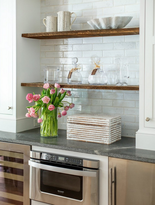 Kitchen wet bar cabinet featuring reclaimed wood open shelves, ivory white cabinets, bluestone countertop and stainless steel appliances. #kitchen #wetbar #kitchenbar Heritage Homes of Jacksonville