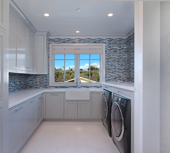 Laundry Room. Laundry room features grey cabinets, tiled drip closet, glass accent walls. Drying racks built in above washer dryer. Patterson Custom Homes. Interiors by Trish Steele of Churchill Design. 