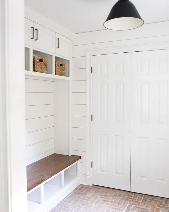 Mudroom brick flooring and shiplap walls. The designer used old Chicago bricks for the floor. Mudroom Paint Color: Farrow and Ball Wimborne White. #mudroom #brickflooring #herringbonebrick Park & Oak Design.