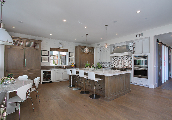 Two toned kitchen. neutral two toned kitchen ideas. The kitchen island and matching pantry features a custom finish to add symmetry to this space. #twotonedkitchen #neutraltwotonedkitchen #neutralkitchen #symmetrickitchen #kitchen Patterson Custom Homes. Interiors by Trish Steele of Churchill Design. 