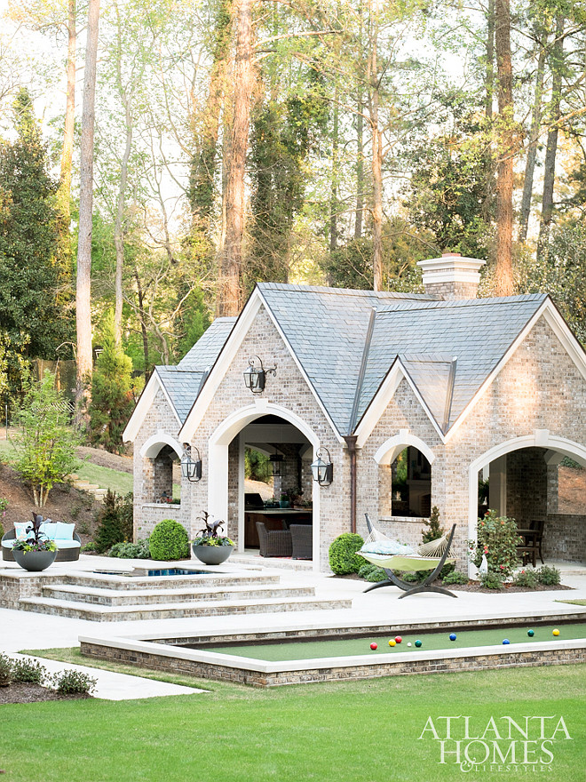 Pool House Design. Pool House Stone Exterior and Slate Roof. Pool House #Poolhouse #pool #backyard #slateroof #stoneexterior #flagstoneexterior #flagstone Mallory Mathison Inc.. Atlanta Homes & Lifestyles.