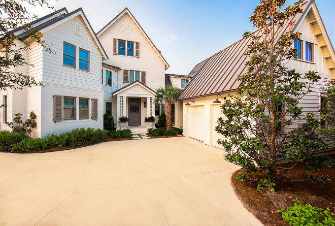 White brick exterior. This new home features painted white brick with white siding and charcoal gray windows and shutters. T.S. Adams Studio, Architects