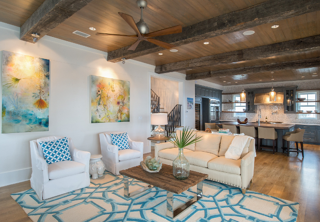 The open living room features stunning reclaimed oak beams with Cypress ceiling. Interiors by Courtney Dickey of TS Adams Studio.
