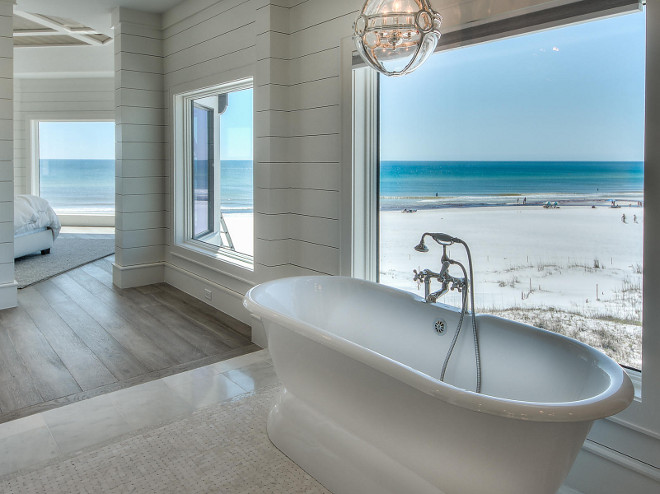 Bathroom shiplap walls. Ocean front bathroom with shiplap walls, freestanding bath and pendant over tub. #Bathroom #shiplap #oceanfront #neutral #hardwood #marbleflooring #pendant #tub #freestandingtub