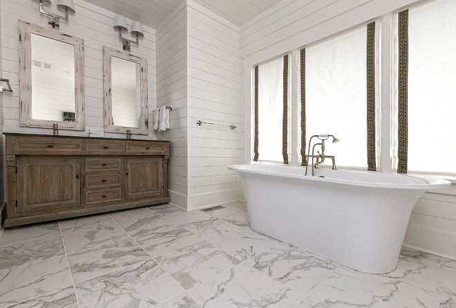 Bathroom with reclaimed wood cabinets, distressed mirrors and shiplap walls. Holly Covington Designs