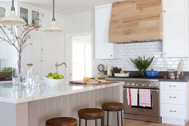 Reclaimed kitchen hood. The wood accent on the range hood is incredibly eye catching and this was where the designer was really able to tie in the concept of the “Modern Farmhouse”. Here, the designer tell us more about the hood: "Our initial design direction was to use reclaimed barn wood to panel the hood and back of the hutch as an accent. However, when I visited the job site as the flooring was being installed, I realized I loved it so much I wanted to use that same cerused oak instead to tie it all together. Best of all, there was no additional cost because there we were able to use the leftover flooring material! 