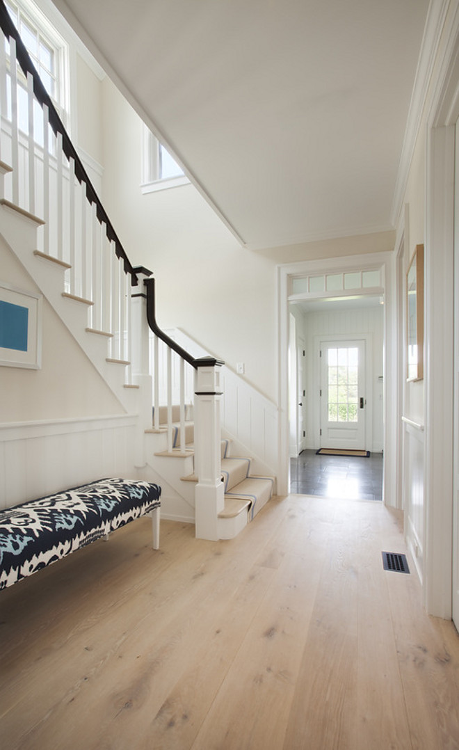 Foyer bench with blue and white ikat fabric and wide plank floors. Lynn Morgan Design.