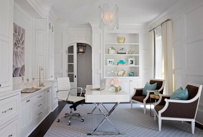 Home Office. This has to be the ultimate home office. I love the millwork, the decor and the furniture. The home office boasts polished chrome x-base desk with white lacquer top paired with white Eames Management Chair. The office also features full wall millwork as well as floor-to-ceiling white built-in cabinets. Dimensions: This room is 13'-10 wide (Left to Right) by 16'-4" length (Front to Back). #homeoffice #millwork #cabinets TS Adams Studio Architects. Traci Rhoads Interiors.