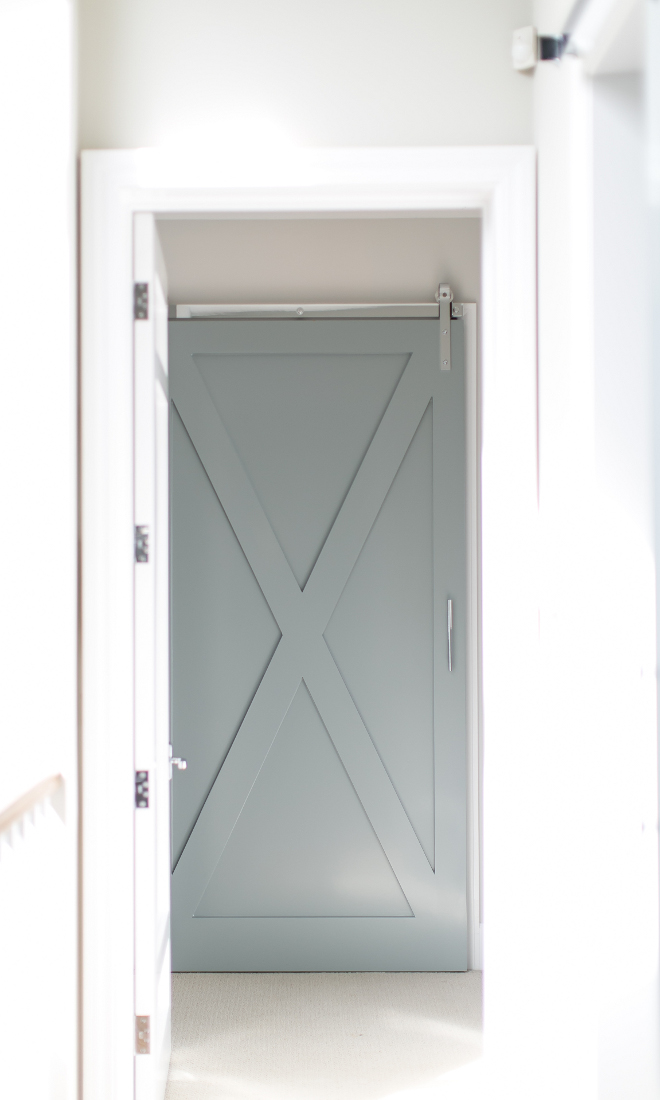 Gray Barn Door in Laundry room. Gorgeous gray laundry room barn door on rails with polished nickel pull. #barndoor #laundryroom #graybarndoor #graydoor Churchill Design.