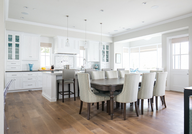 Kitchen and dining area. The kitchen opens to a neutral dining areal with custom chairs. Brandon Architects, Inc. Churchill Design. Legacy CDM Inc.