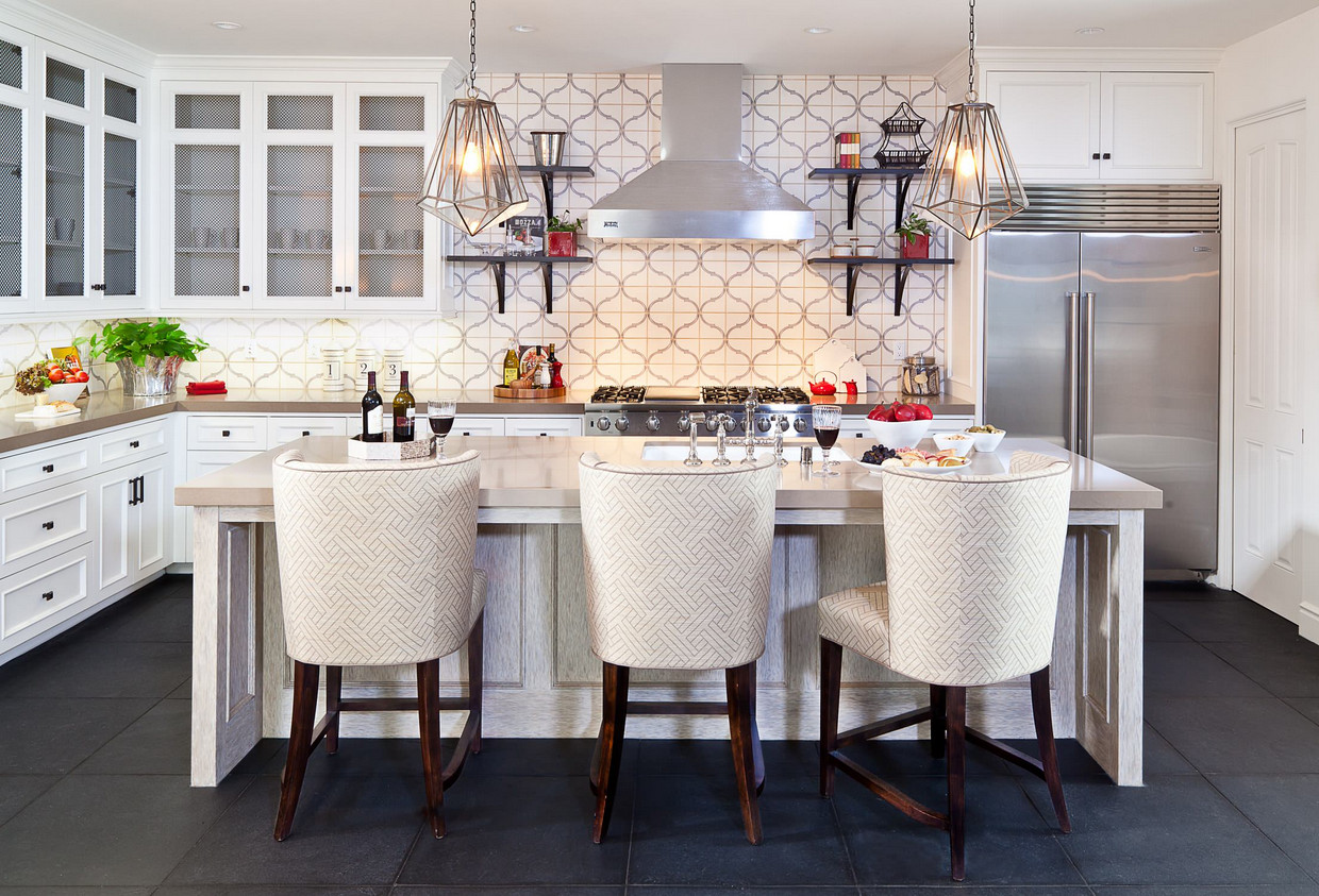 Kitchen. Kitchen Backsplash and Flooring. A custom hand painted backsplash creates a graphically subtle backdrop that balances the light and dark finishes in the room. Caesarstone countertops were specified along with professional series Sub Zero and Viking stainless steel appliances. The Tile backsplash was custom made for the house. It is 12 x 12 limestone cut down to 6 x 6 and then hand painted with the design. D for Design