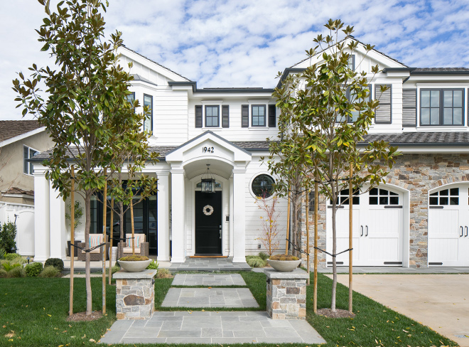 Home Exterior. The exterior of this home combines white siding, black windows and hand selected stone in browns and greys. #HomeExterior #siding #stones #windows #colors Brandon Architects, Inc. Churchill Design. Legacy CDM Inc.