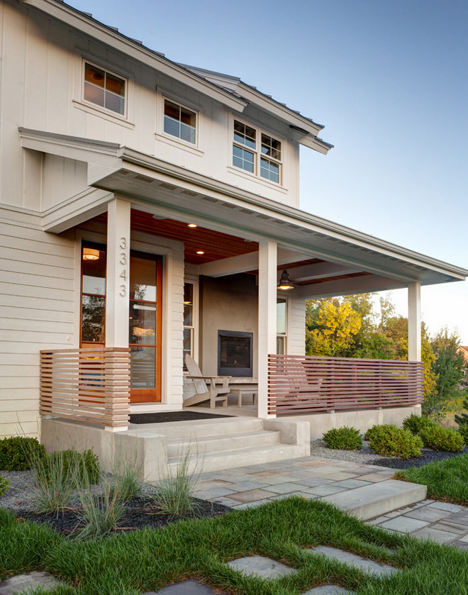 Porch railing. This modern farmhouse porch railing is made out of clear-coated 2x2 cedar spaced two inches apart. #porch #railing AMEK Custom Builders. Martha O'Hara Interiors