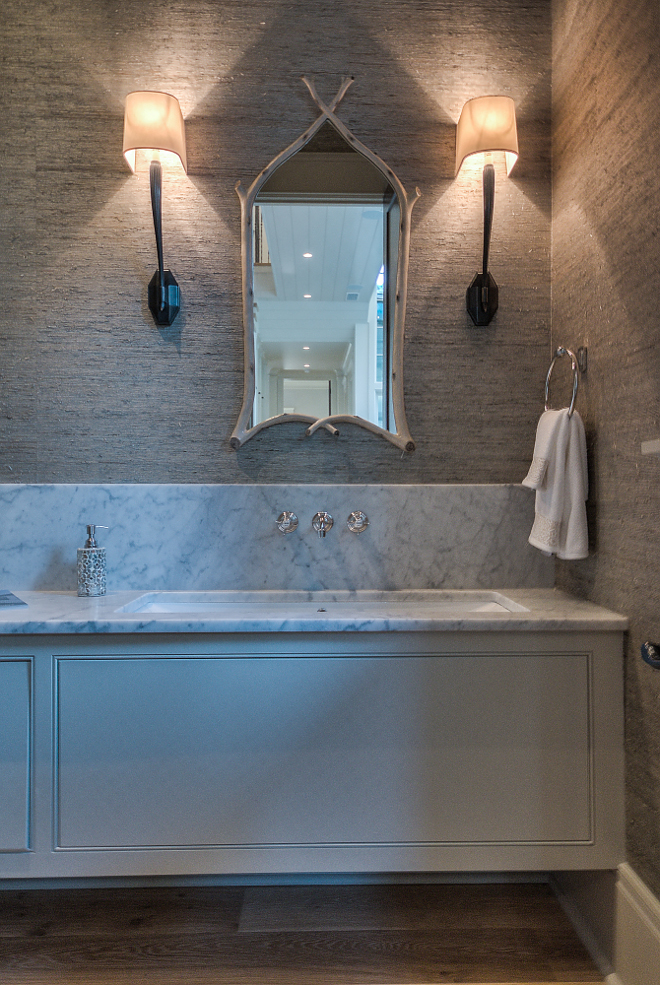 Powder Room Sconces. Powder room features grasscloth wallpaper and a pair of Ruhlmann Single Sconces. Finish Bronze. #RuhlmannSingleSconce