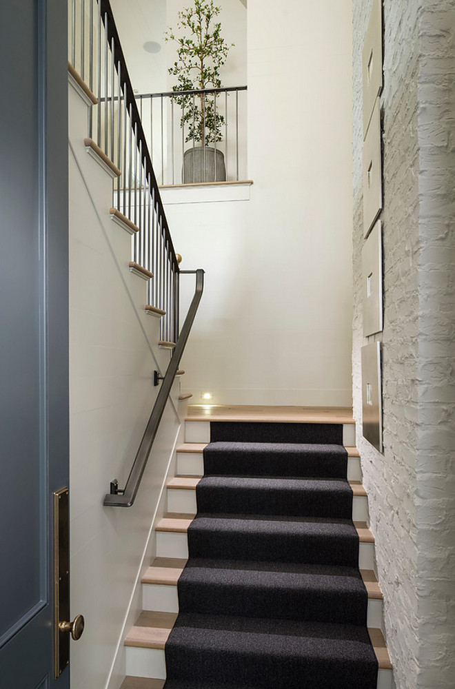 Staircase with exposed brick painted in white and custom railings. #Staircase #ExposedBrick #Stairs #Railings Jackson and LeRoy