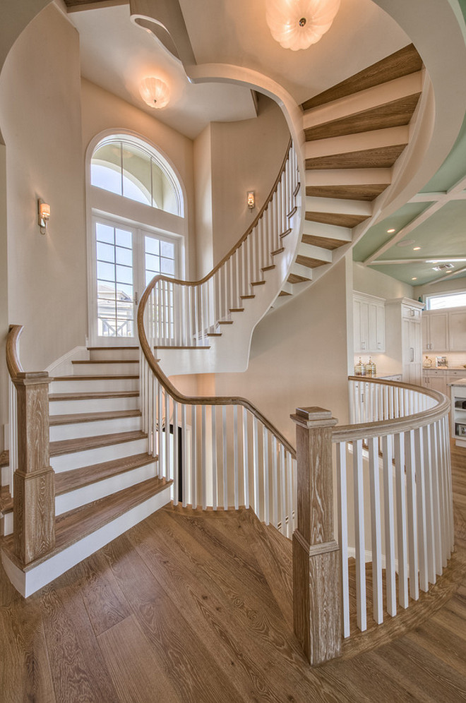 Staircase. Staircase flooring is wire brushed white oak. The designer added wood on both sides of the staircase (floor and ceiling) to add interest to the staircase.