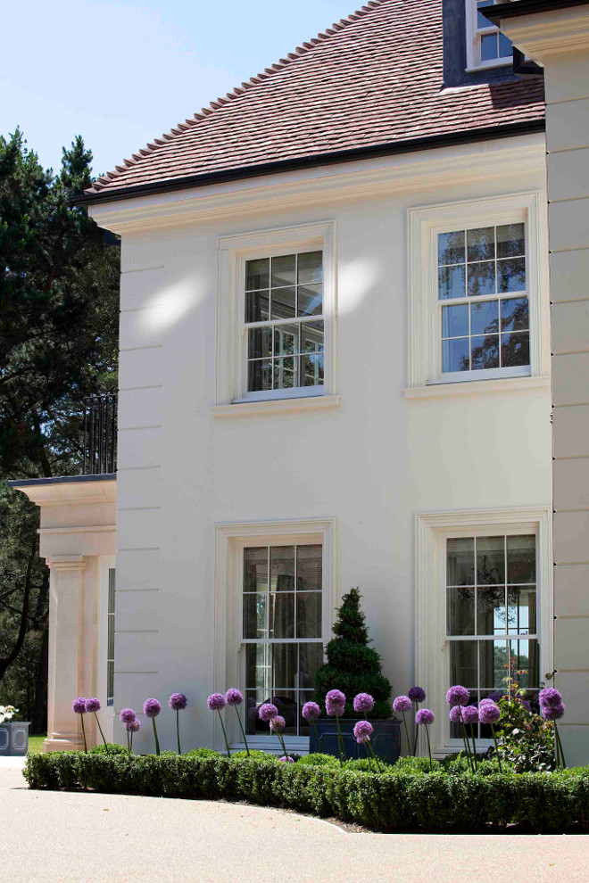 Ivory white home. This ivory white home beautifully contrasts with the lush landscaping. #IvoryWhiteHome #Ivorywhite #exterior #homeexterior Hayburn & Co. 