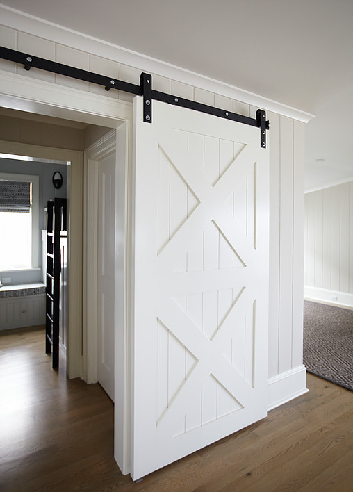 Barn door with X-Mullion. Bunk room features a sliding Barn door with x-mullion design. #Barndoor #xmullion #slidingbarndoor #bunkroom