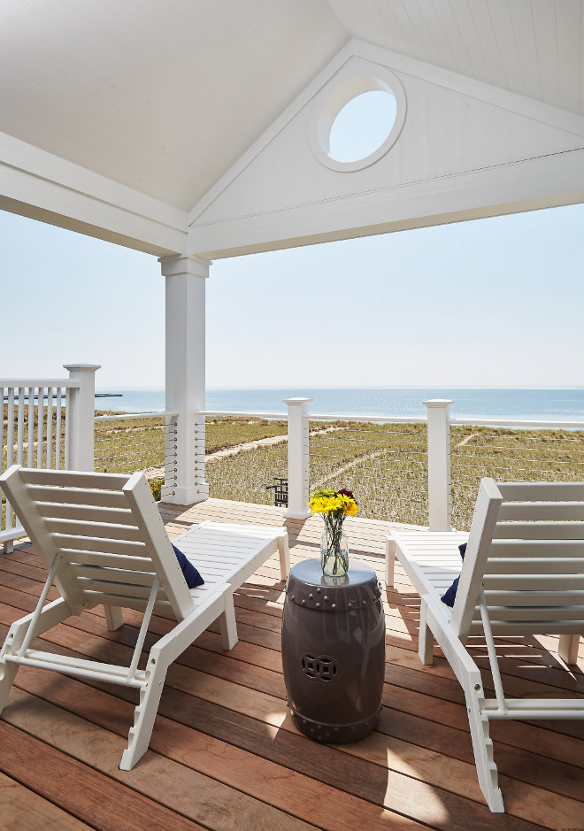 Deck ideas. Deck with cable railing, vaulted ceiling painted in Benjamin Moore PM-1 Super White exterior paint and Ipe deck wood. Mike Schaap Builders