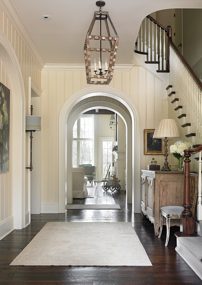 Traditional Foyer with archway. Foyer. Beautiful foyer with archways and rustic dark hardwood floors. Floors are 8"-10" wide antique heart pine plank wood floors, dark stained and scraped. Ceiling paint color: Benjamin Moore Cloud White CC-40. Lighting: Most lighting used in this home are antique finds. T.S. Adams Studio. Interiors by Mary McWilliams from Mary Mac & Co. 