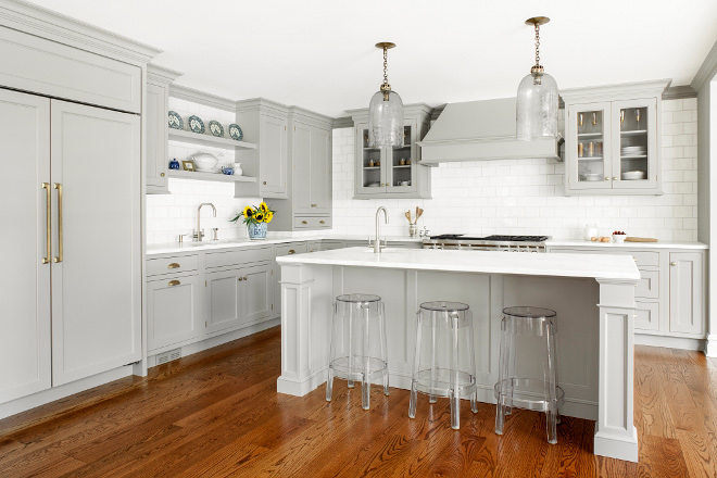 Gray Kitchen. When Michelle and Dale approached Heidi Piron from Heidi Piron Design & Cabinetry about renovating the kitchen in their center hall Colonial in Summit, NJ, they wanted to open it into a family room and breakfast area. With three children -- a son in college, a daughter in high school and a son in middle school -- the household is a whirl of activity. As with the other more public spaces in the house, they wanted the kitchen to be quiet and minimal in feeling as a counterpoint to their busy, "gear-and-stuff-filled lives," as Michelle described it. Michelle's design aesthetic is a blend of traditional and contemporary. She gravitates towards the antique and the artisanal, which Heidi incorporated in this custom gray kitchen. Heidi Piron Design & Cabinetry