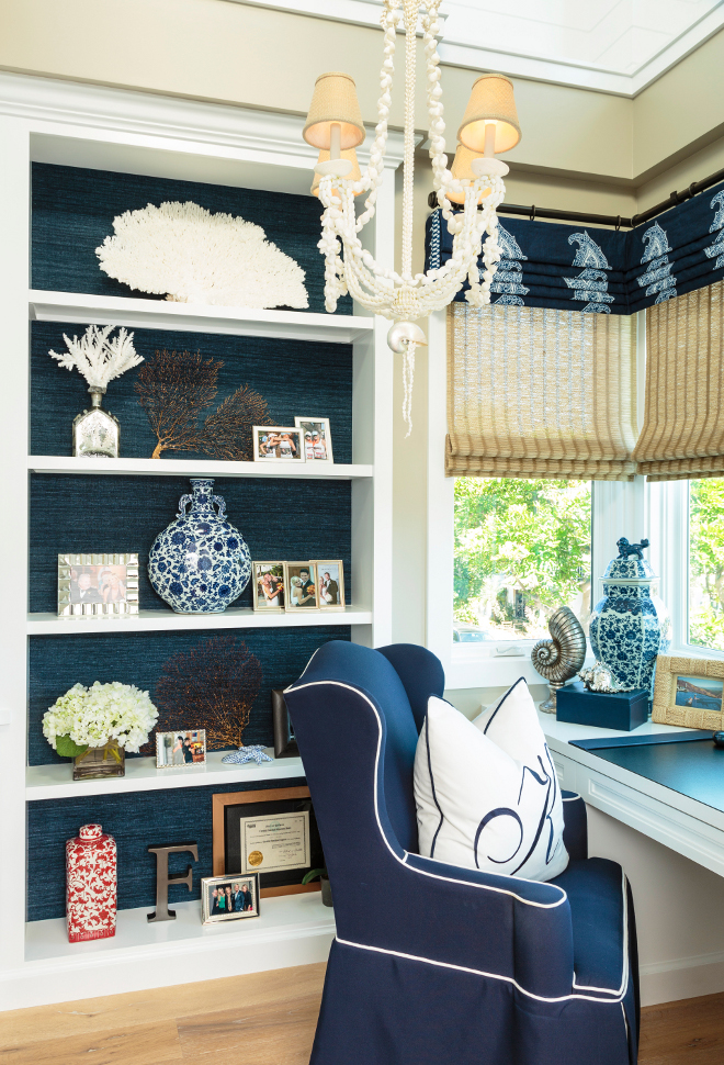 Home Office Bookcase with grasscloth wallpaper and coastal decor. Home office bookcase. I usually prefer small offices over big ones. I find that big spaces can overwhelm you and take some of your focus away. This home office not only is beautiful but it's also very comfortable and functional! Chair is a "Barclay Butera Hudson Host Chair". Shell chandelier is a Currey & Company chandelier. #Homeoffice #Bookcase #grasscloth #wallpaper #coastaldecor Barclay Butera Interiors.