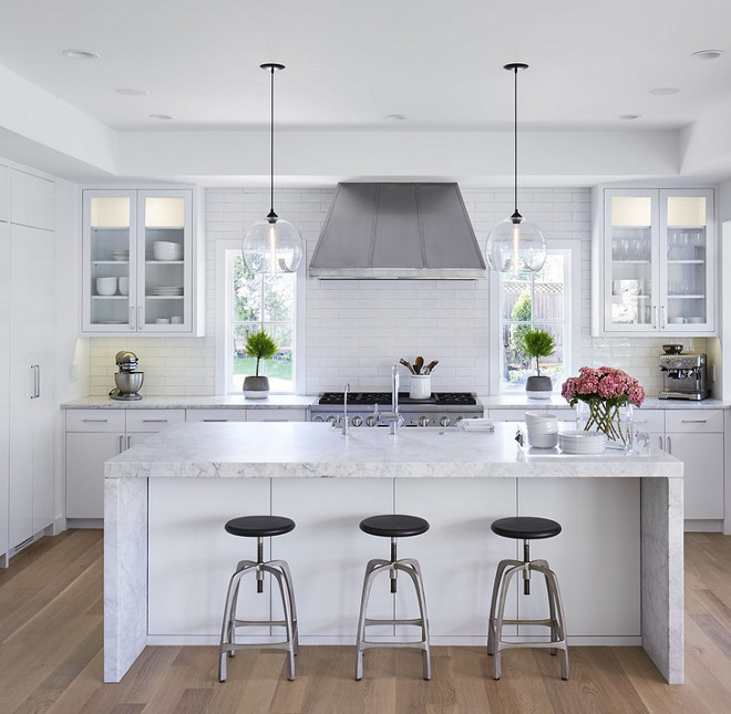 Kitchen reno with white cabinets. White kitchen renovation ideas. The kitchen was completely renovated and it now feels bright and open. Cabinetry: Paint Grade Wood - Paint Color: "Benjamin Moore Super White OC-152" in a white lacquer finish. #whitekitchenreno #kitchenreno #whitekitchenrenovation #BenjaminMooreSuperWhite Martha O'Hara Interiors