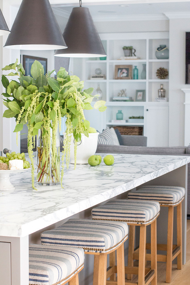 Kitchen island with marble countertop and striped counterstools. Beautiful Kitchen island with marble countertop and striped counterstools. #Kitchenisland #marblecountertop #stripedcounterstools Blackband Design