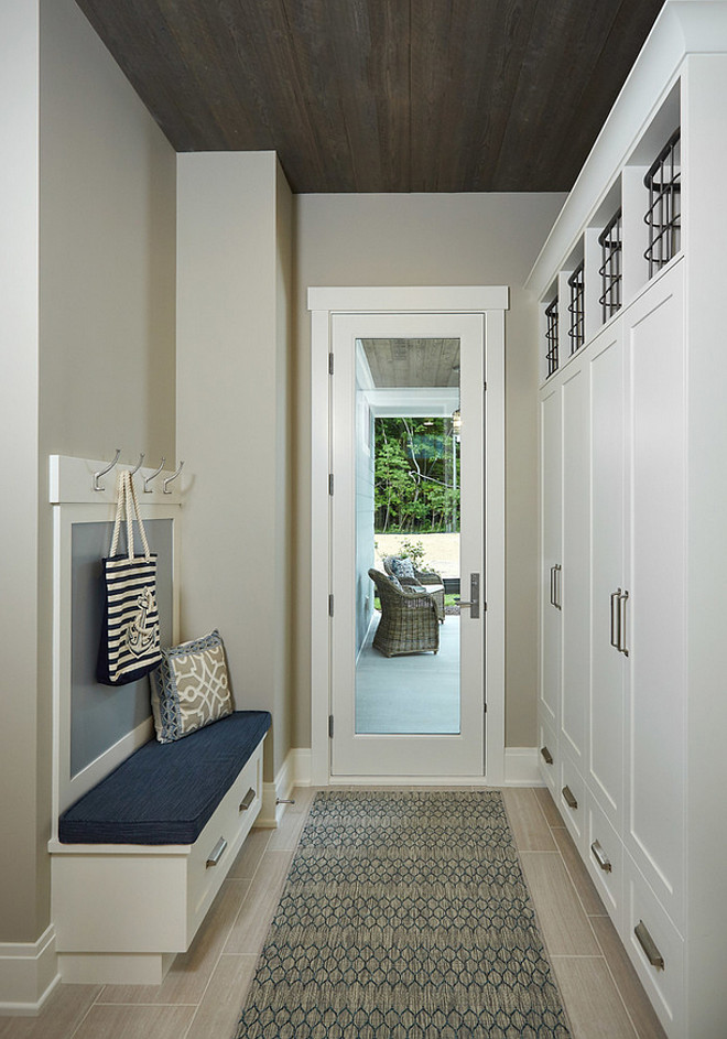 Mudroom with reclaimed wood ceiling. Neutral mudroom with white cabinets and reclaimed wood ceiling. Reclaimed wood used on ceiling is Ghost Wood. #Mudroom #ReclaimedWoodCeiling #WoodCeiling #Ghostwood