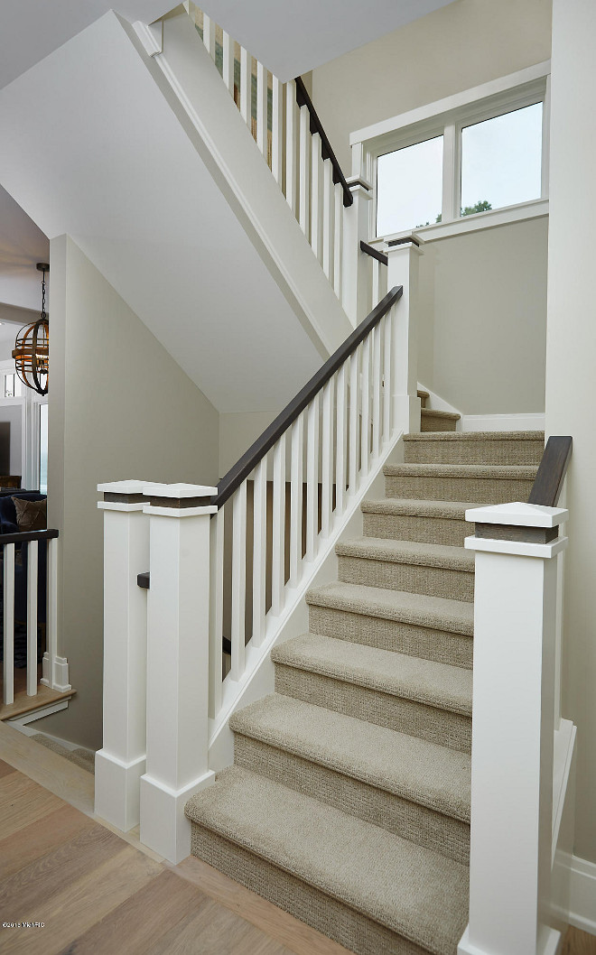 Neutral staircase walls painted in Revere Pewter by Benjamin Moore. Staircase balusters and spindles paint color is White Dove by Benjamin Moore. #Staircase #wallpaintcolor #ReverePewterByBenjaminMoore #WhiteDovebyBenjaminMoore #Staircase #balusters #spindles #paintcolor