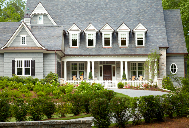 Picket Fence. Stone home with white picket fence. Home features shingle and stone exterior. T.S. Adams Studio. Interiors by Mary McWilliams from Mary Mac & Co.