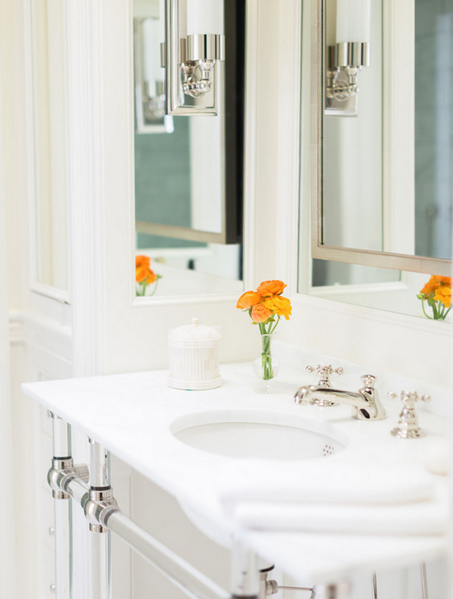 Washstand. Nickel and glass washstand topped with marble placed under a satin nickel mirror. #washstand Sarah Bartholomew Design