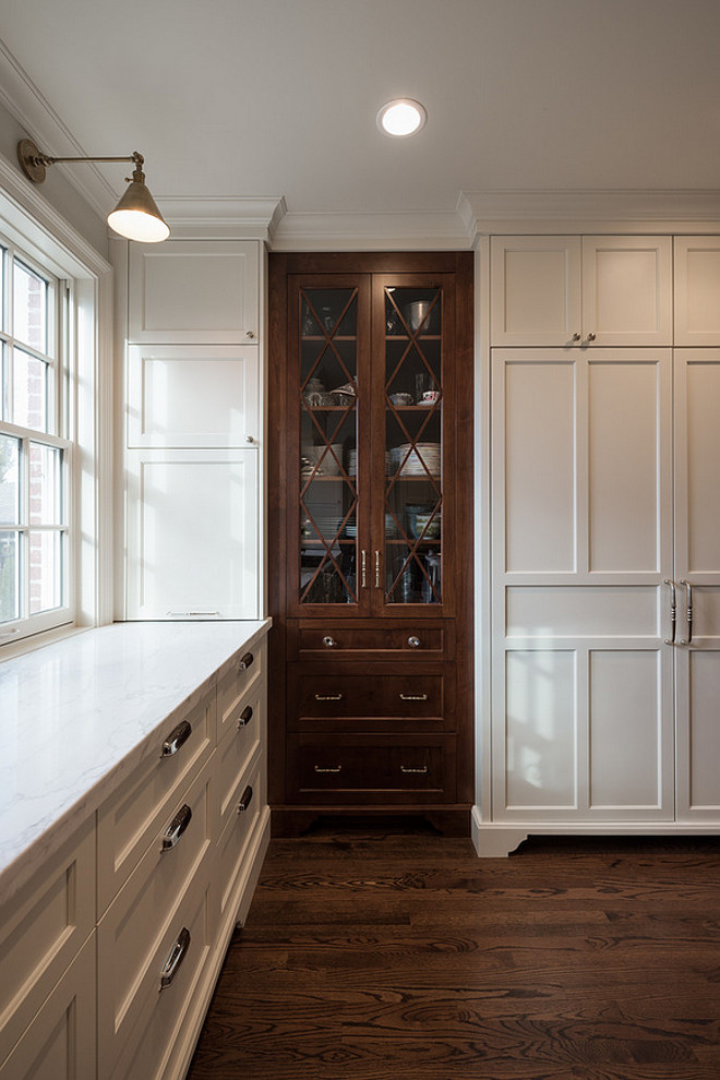 White Kitchen with china cabinet stained in walnut. White kitchen with dark walnut china cabinet. #Whitekitchen #darkwalnut #chinacabinet Northstar Builders, Inc.