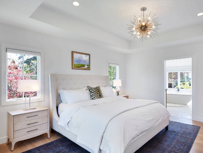 White bedroom paint color. This Scandinavian-inspired bedroom has a calming feel thanks to its crisp white walls and clean-lined decor. Wall paint color is, once again, Benjamin Moore Super White OC-152, in flat finish. Notice the tray ceiling. Martha O'Hara Interiors