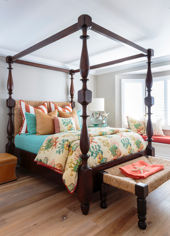 In this bedroom, a tropical coastal color palette contrasts beautifully against soothing wall color and matte wide plank floors. Barclay Butera Interiors.