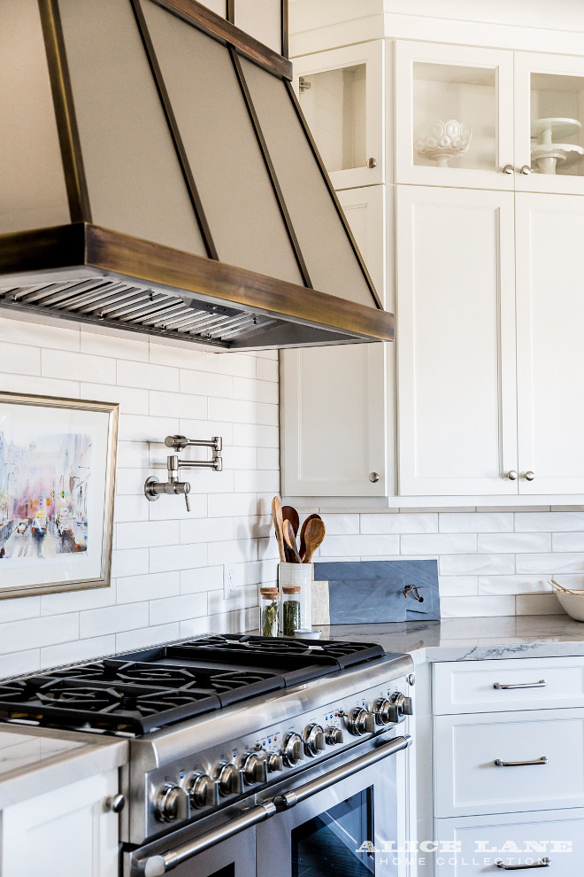 Zinc and aged brass kitchen hood. Kitchen hood. Zinc and aged brass kitchen hood with white backsplash tile and white cabinets. #Zinchood #agedbrasskitchenhood #kitchenhood Alice Lane Home.