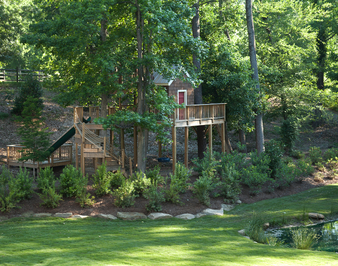 Treehouse with slide. The homeowner's kids have a dream treehouse with its own slide and pond view! T.S. Adams Studio. Interiors by Mary McWilliams from Mary Mac & Co.