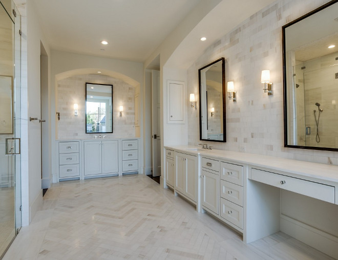 Bathroom with vanities tucked into arched nooks and herringbone marble floor tiles. Bathroom with vanities tucked into arched nooks and herringbone marble floor tiles #Bathroom #vanities #archednooks #herringbonetile #marblefloortiles Robert Elliott Custom Homes